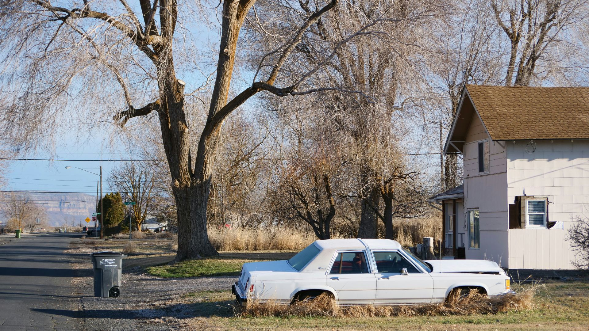 a white car parked on the side of a road