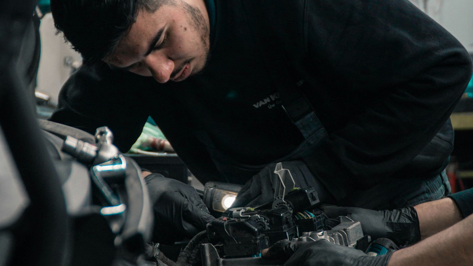 mechanic working on car engine