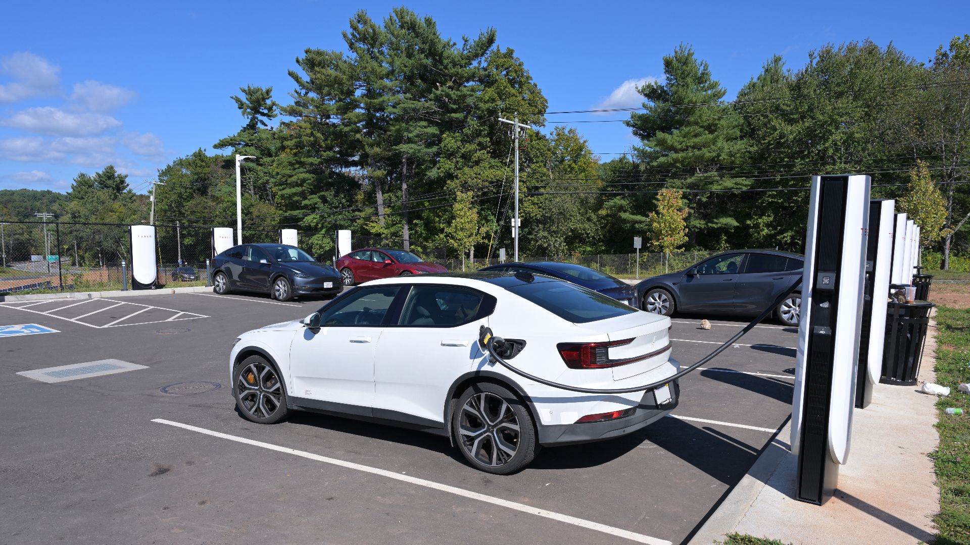 A 2021 Polestar 2 charges at a Tesla Supercharger in Willington, Connecticut