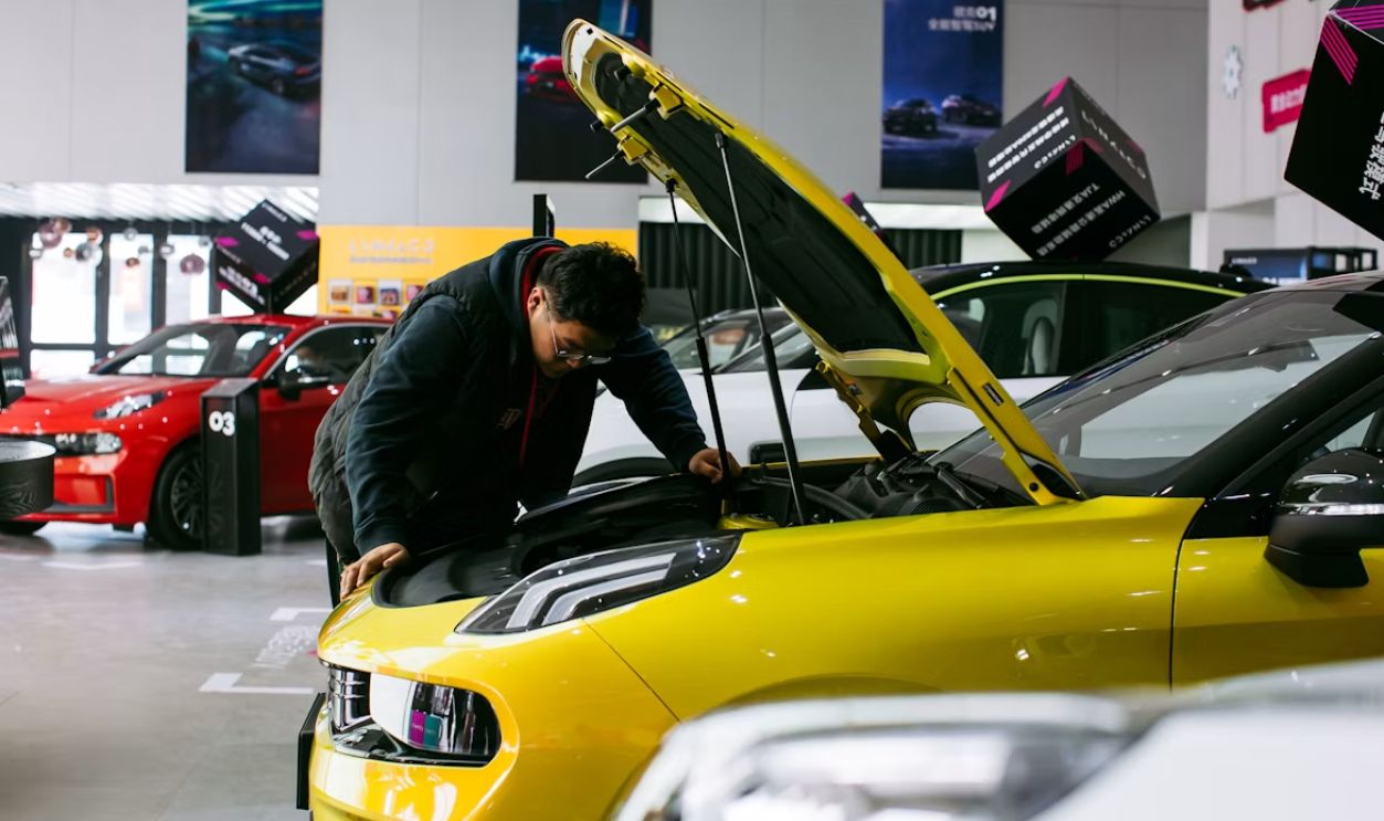 Car mechanic inspecting