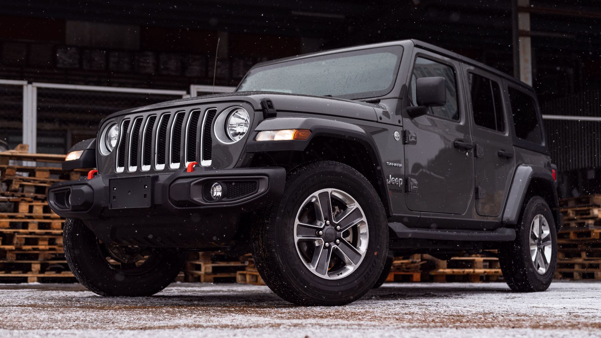 A rugged Jeep Wrangler parked on a snowy day, highlighting its robust design.
