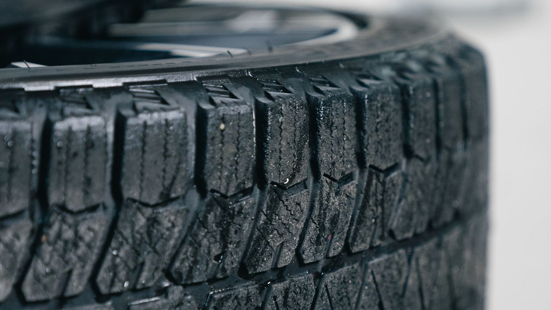 Detailed focus on stacked car tires showcasing intricate tread patterns for grip and traction.