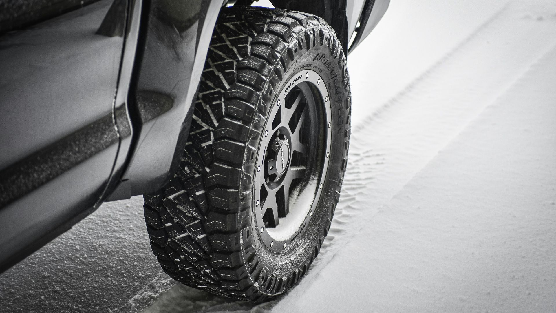 grayscale photo of car wheel