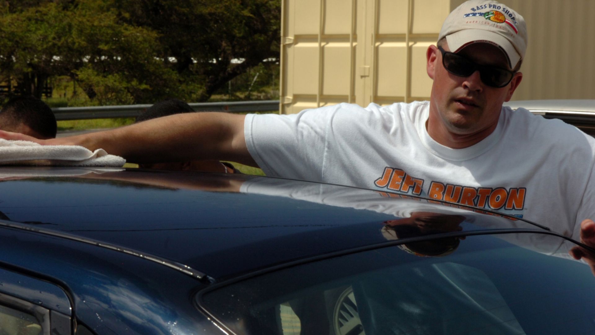 Army Staff Sgt. Thomas Macagg wipes a newly cleaned car dry at the Joint Task Forces' Joint Detention Group Ball Carwash fundraiser, May 24, at the car washing station near the Lyceum Theater. The car wash was held as a fundraiser for the JDG Ball in Sept