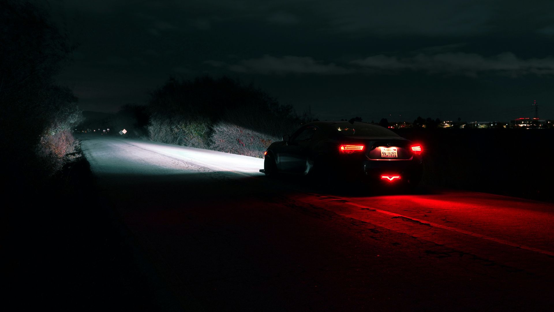 Car driving on a dark road at night