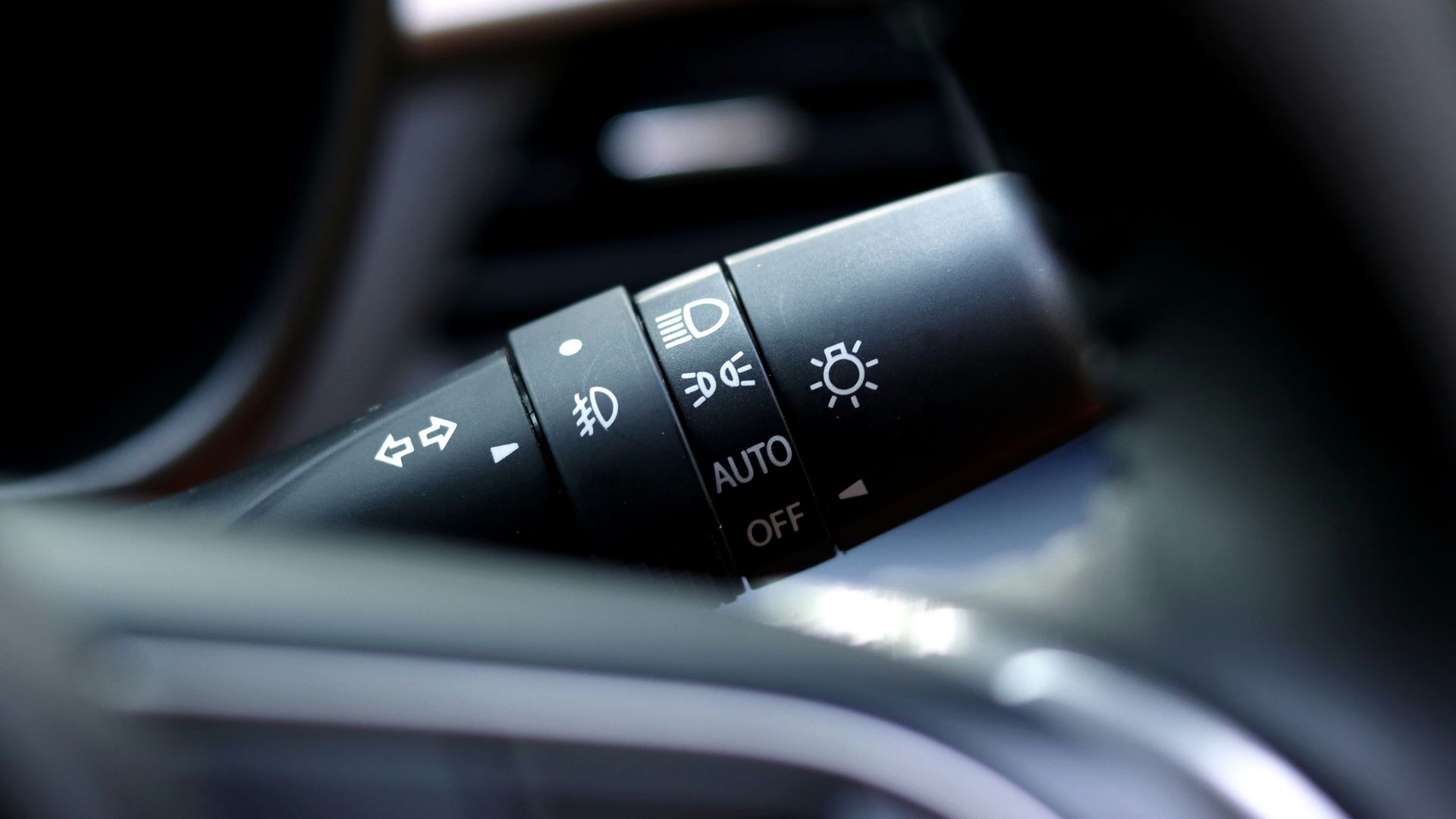 a close up of the buttons on a car's steering wheel