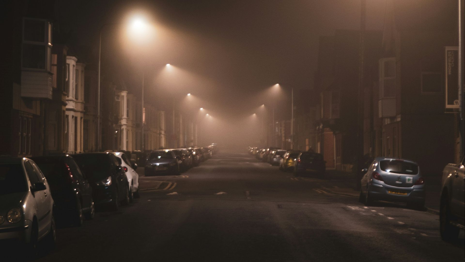 cars parked on side of the road during night time