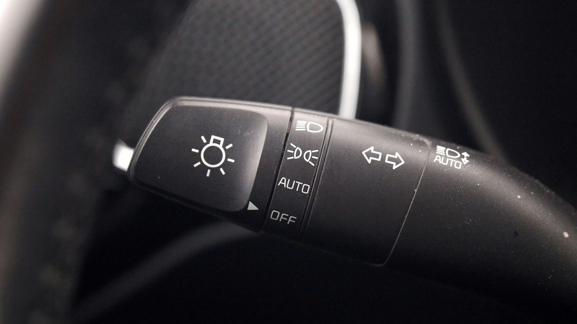 A close up of a steering wheel with buttons