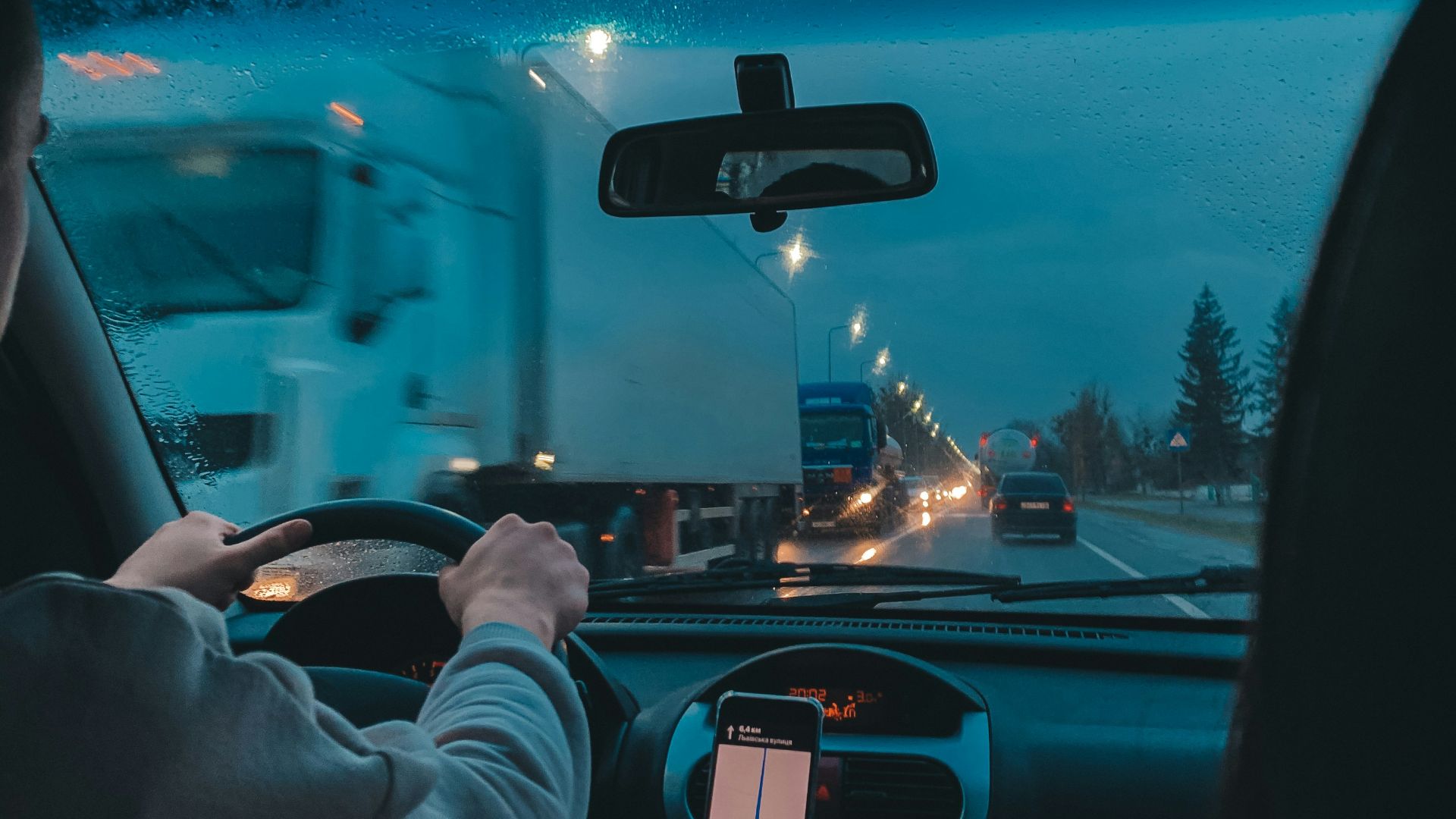 person in gray long sleeve shirt driving car