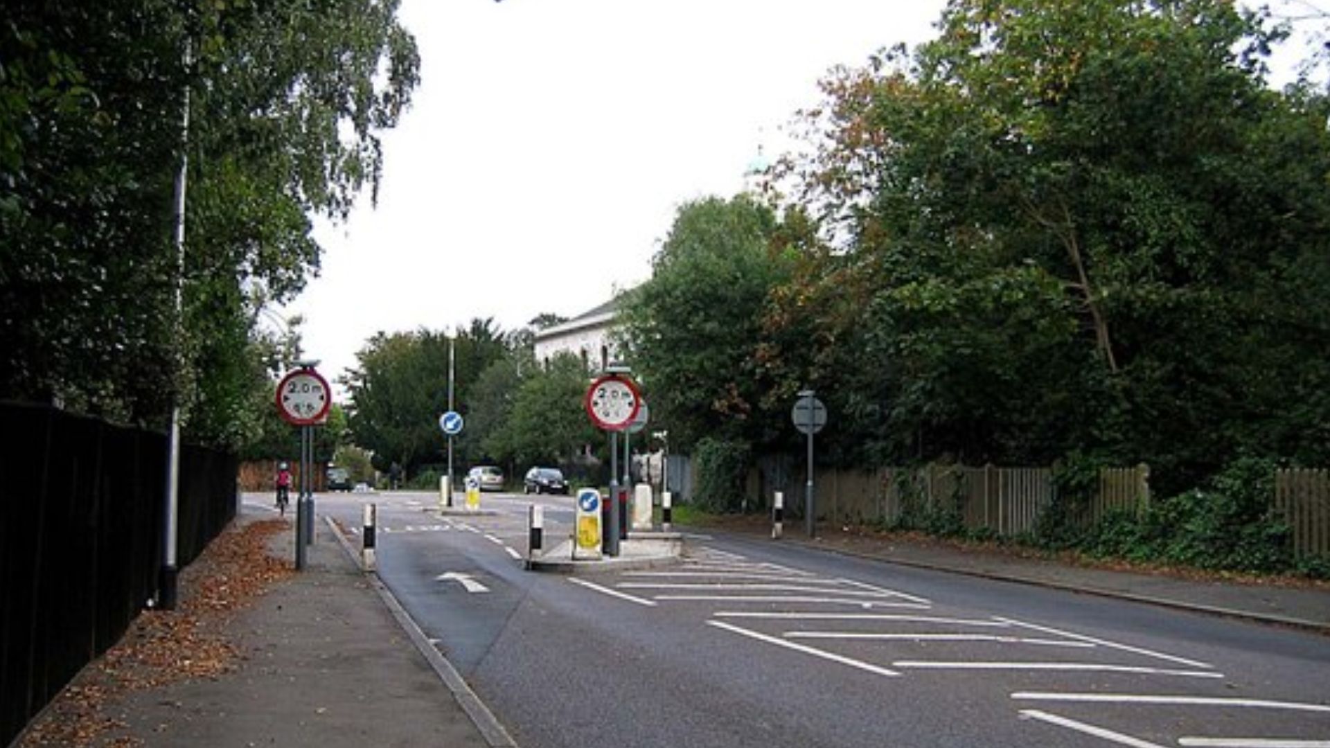 Traffic Calming Measures on Overton Drive. Vehicles are forced to steer between two posts placed 2 metres apart. Scraped paint on each post suggests that they don't always succeed!