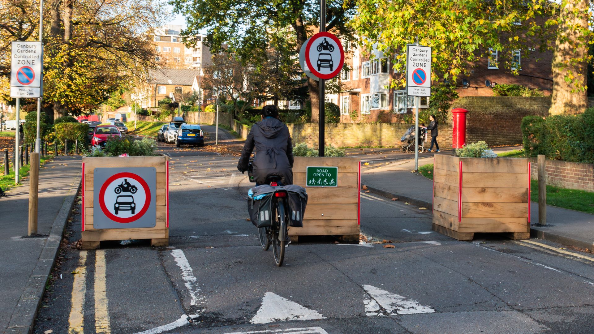 Low Traffic Neighbourhood (LTN) trial - Lower Ham Road, Kingston upon Thames. The modal filter allows cycles and pedestrians to pass - the circular signs indicate that no motor vehicles are allowed through.