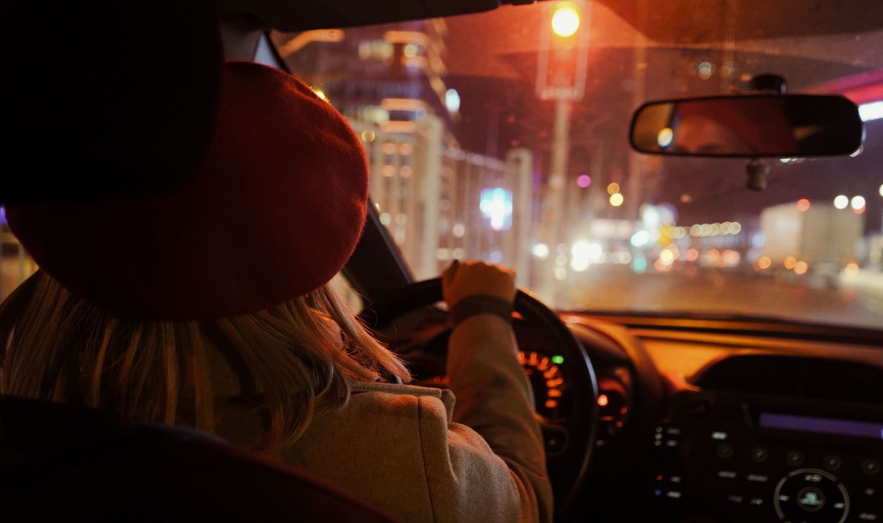 Rear view of a woman driving through Istanbul at night