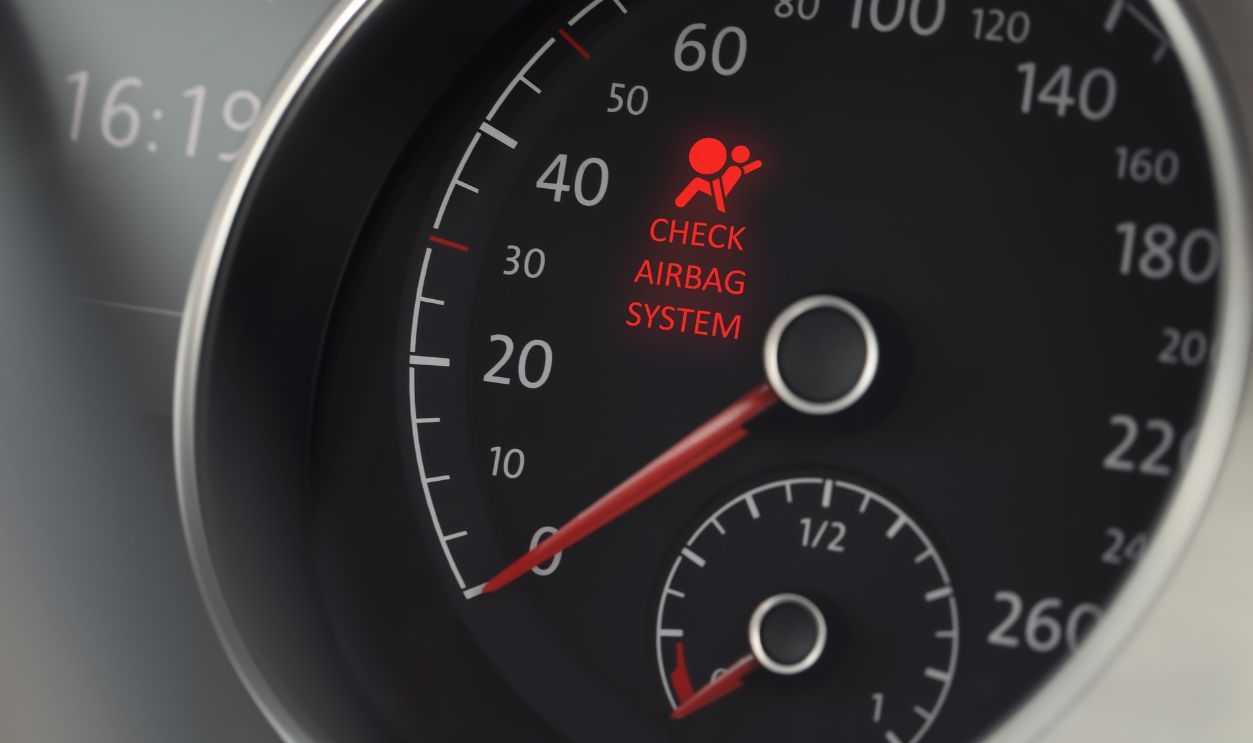 Closeup view of dashboard with warning icon check airbag system in car