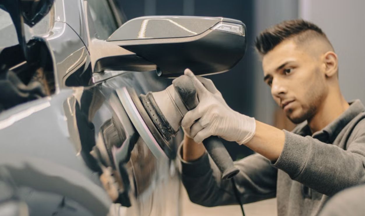 man polishing car