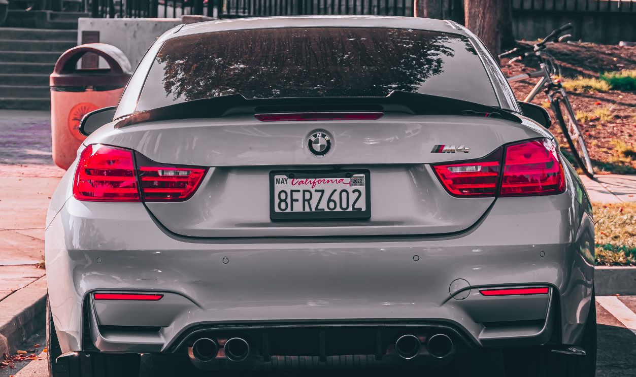 Rear view of a gray BMW parked in a San Francisco parking lot on a sunny day