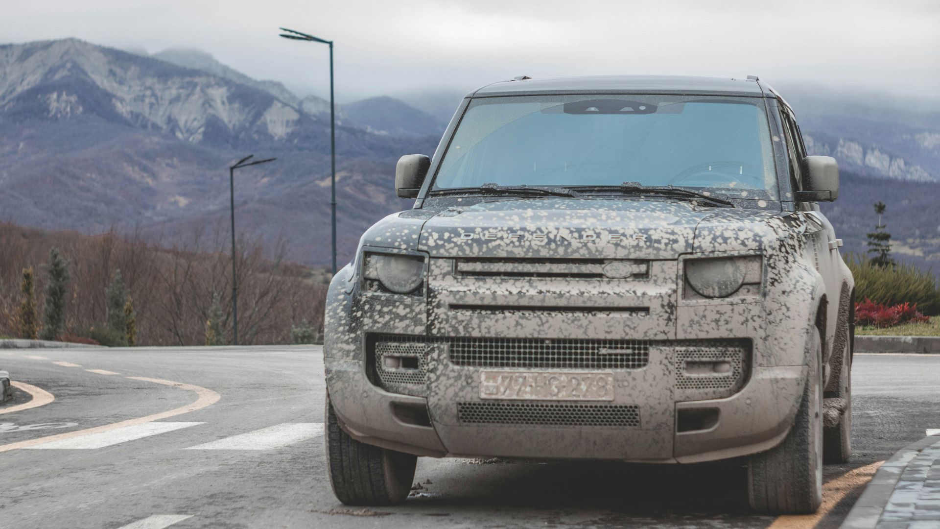 a silver truck parked on the side of a road