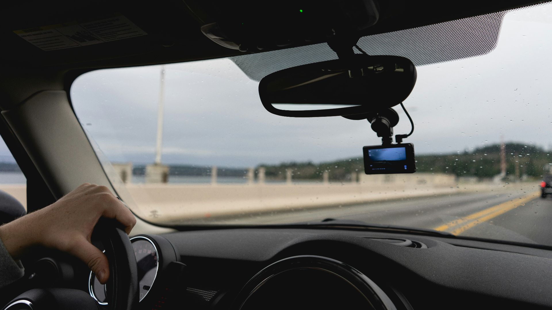 a person driving a car on a highway