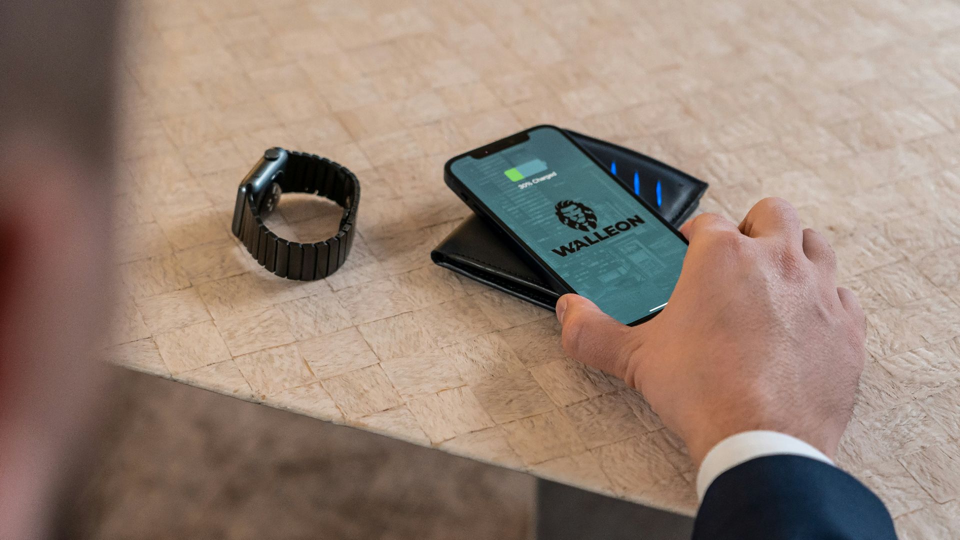a man holding a smart phone next to a smart watch