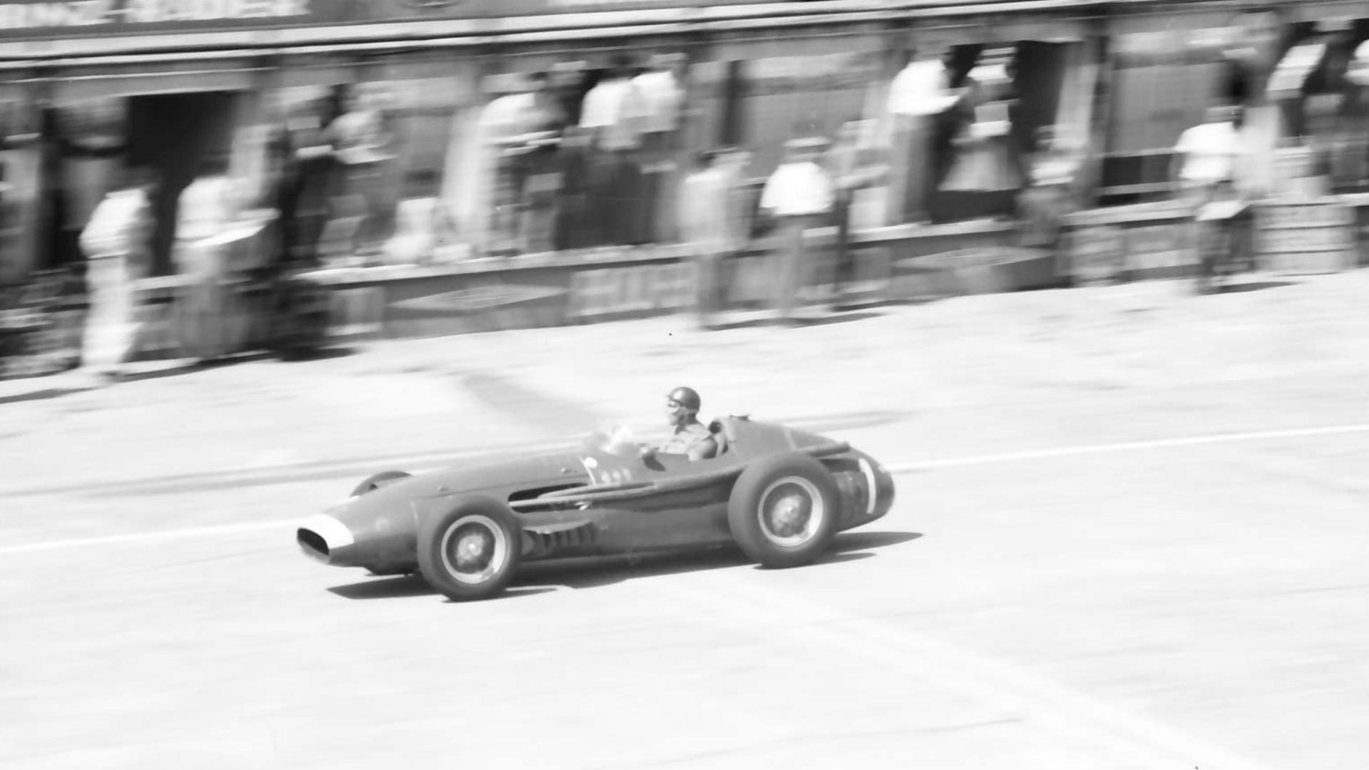 Reigning World Drivers' Champion, Juan Manuel Fangio, in a Maserati 250F car, leading the 1957 German Grand Prix at the Nürburgring, West Germany.