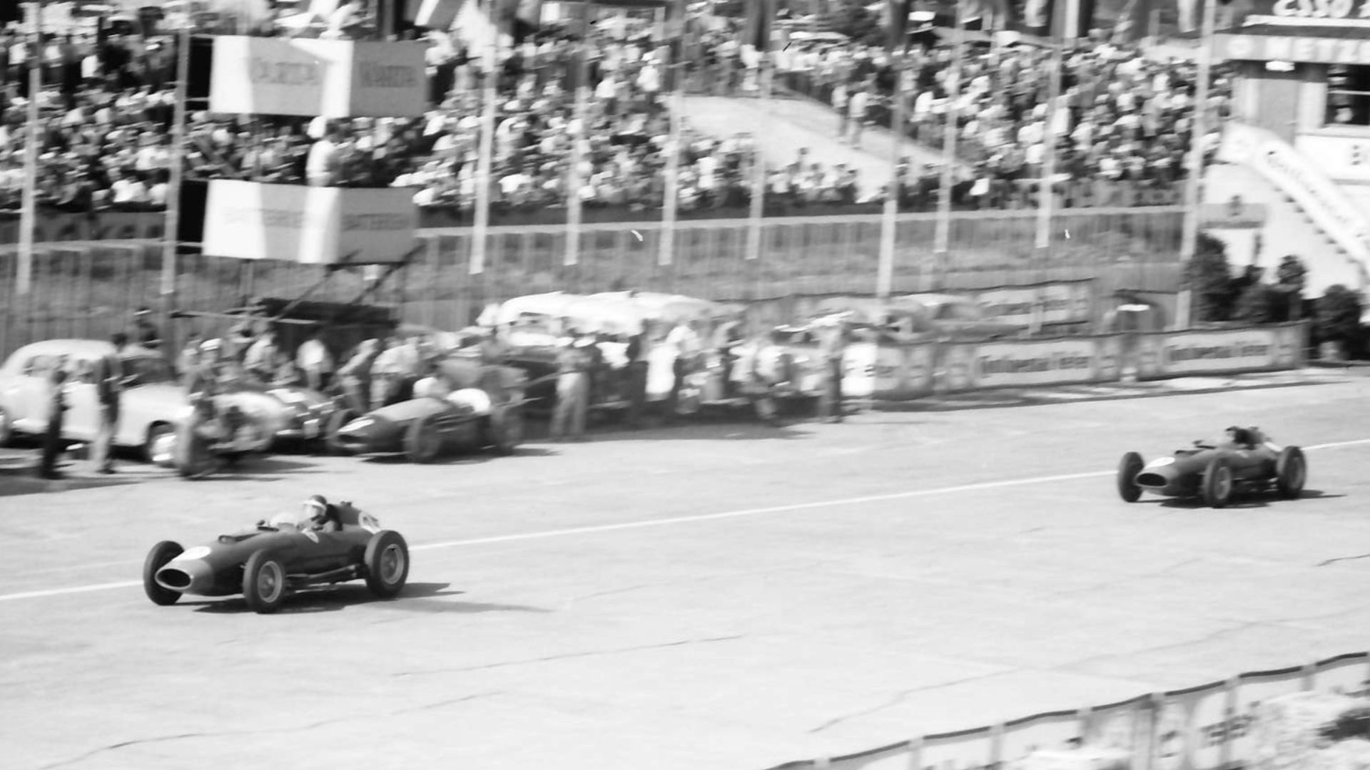 The Ferrari 801 cars of Mike Hawthorn (leading) and Peter Collins pass the retired Maserati 250F car of Paco Godia, in the latter stages of the 1957 German Grand Prix at the Nürburgring, West Germany. Hawthorn and Collins would eventually finish the race 