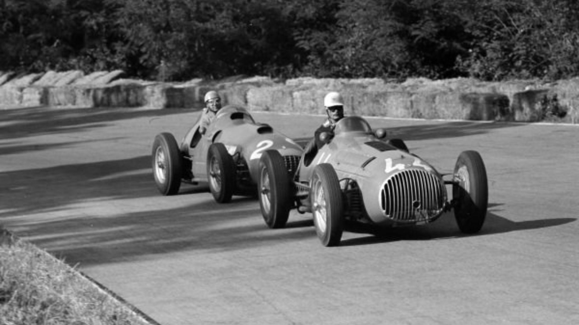AUTODROMO NAZIONALE MONZA, ITALY - SEPTEMBER 16: Franco Rol, OSCA 4500G Osca leads Alberto Ascari, Ferrari 375 during the Italian GP at Autodromo Nazionale Monza on September 16, 1951 in Autodromo Nazionale Monza, Italy. (Photo by LAT Images). Extra info: