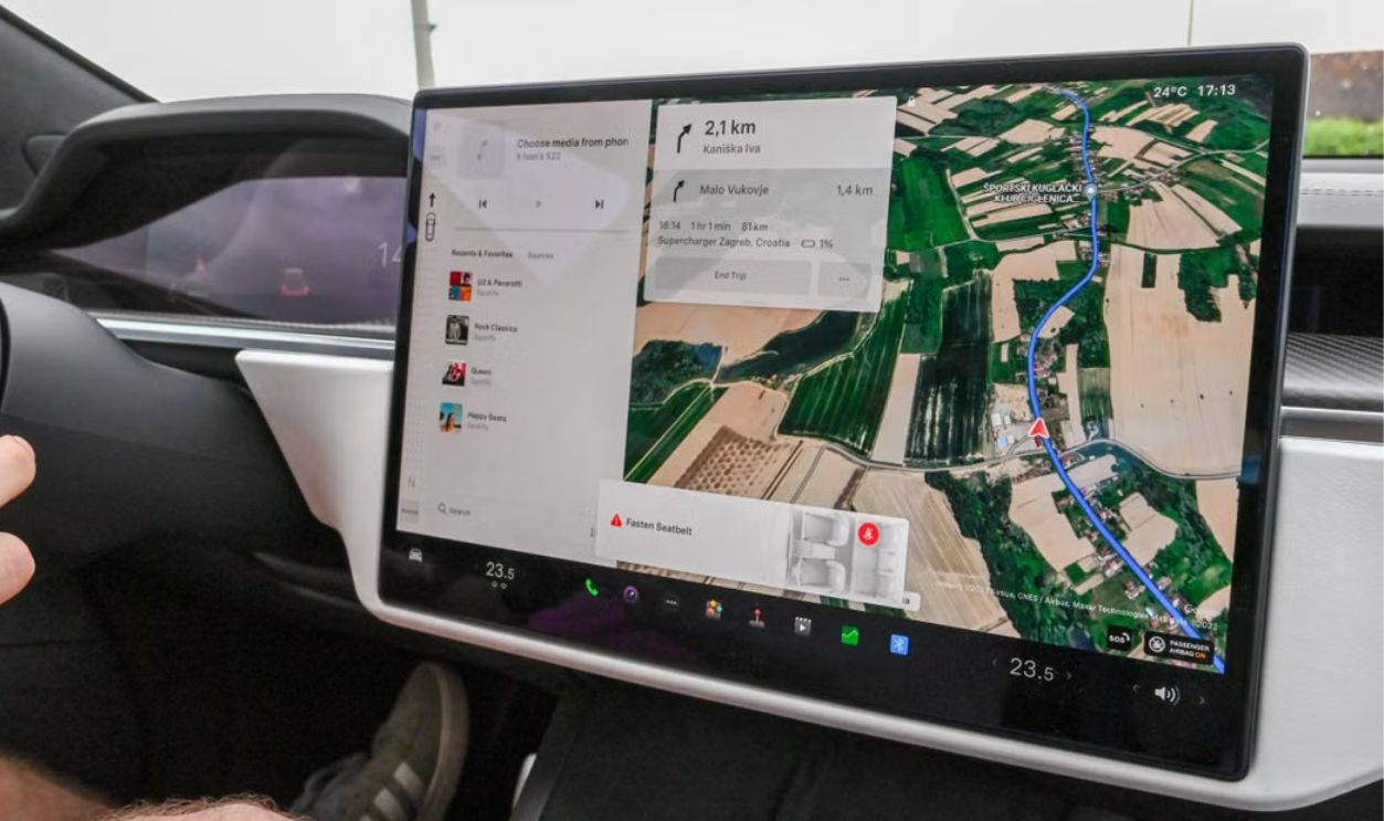 Inside view of a car with a large navigation screen and detailed digital map.