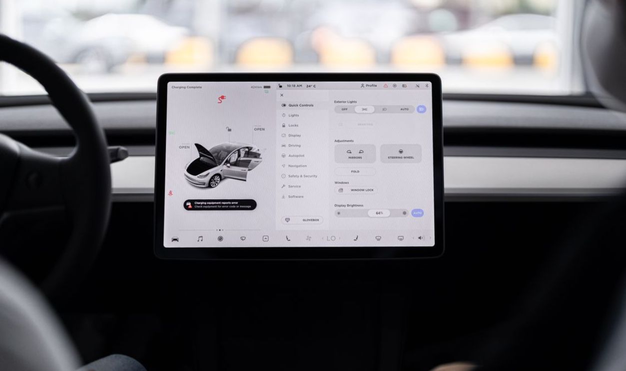 View of a modern car's dashboard featuring a digital display panel with control options.