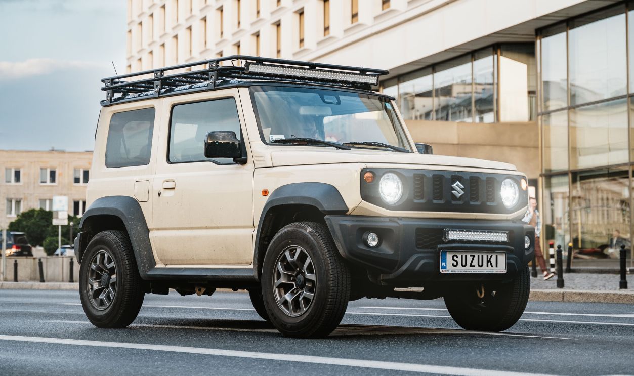 Beige Suzuki SUV driving in Warsaw
