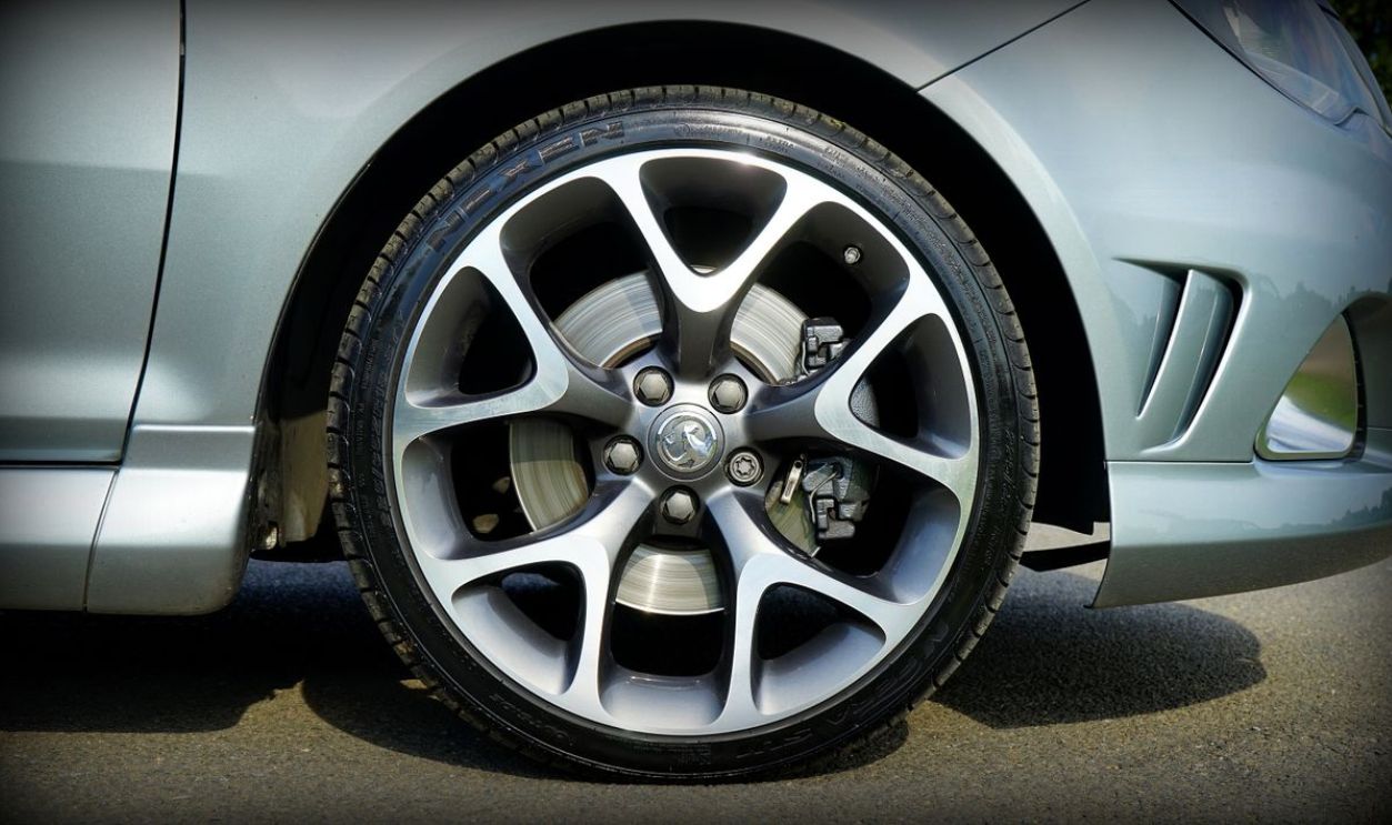 Detailed view of a silver car wheel, showcasing the alloy rim and tire on a Vauxhall model