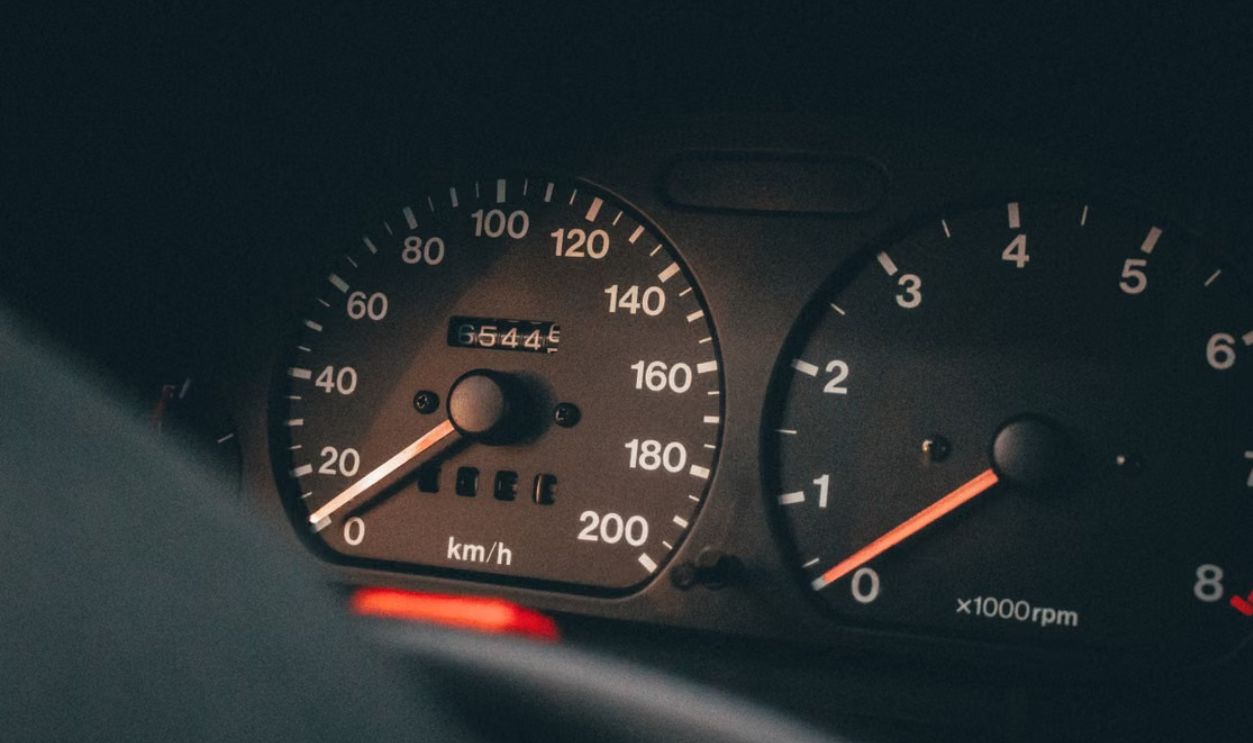 Detailed view of a car's speedometer and tachometer displaying speed and RPM