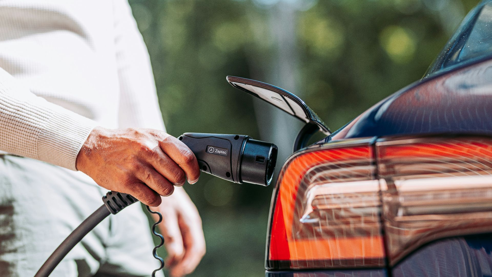A man pumping gas into his car at a gas station