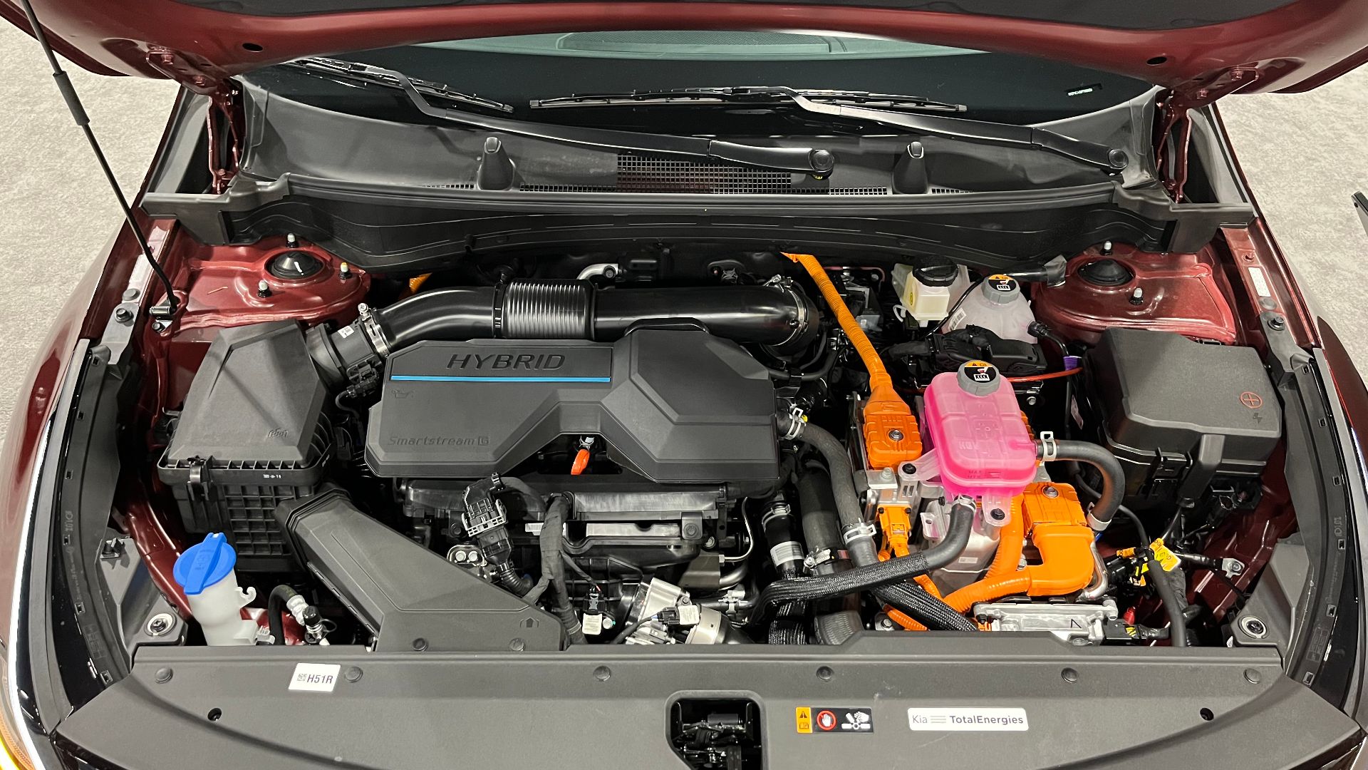 The engine bay of a 2023 Kia Sportage Hybrid SX Prestige AWD at the 2023 Denver Auto Show.