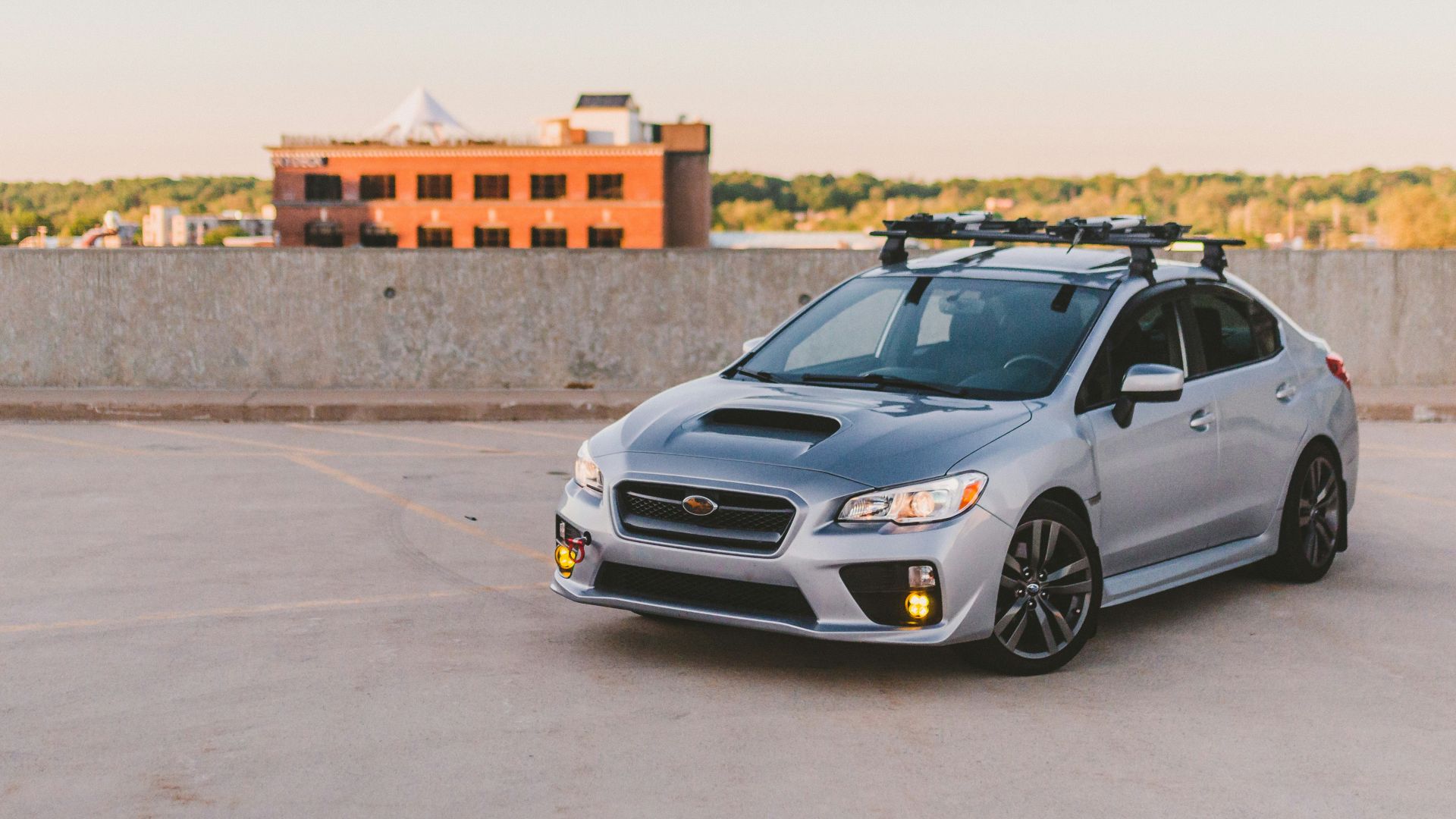 a silver subarunt parked in a parking lot
