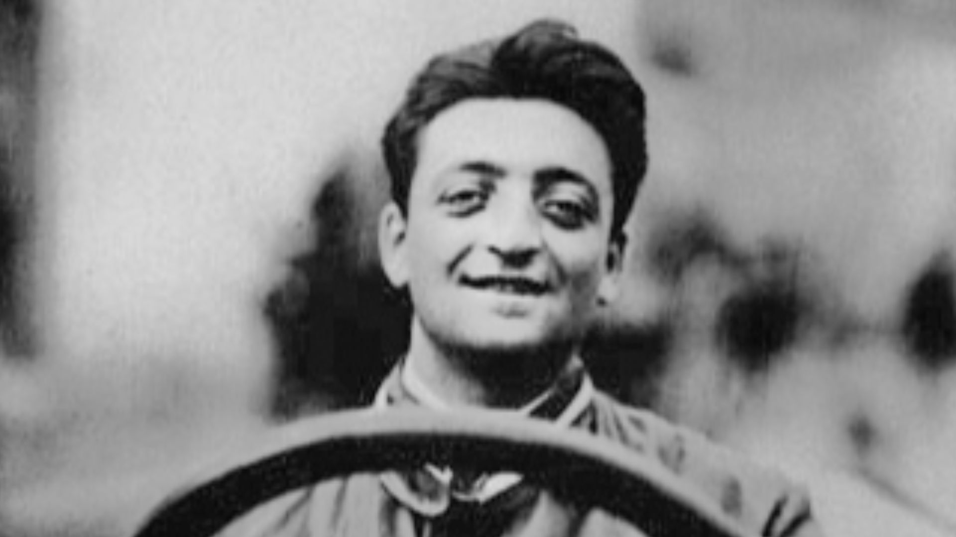 Enzo Ferrari at the wheel of a racing car