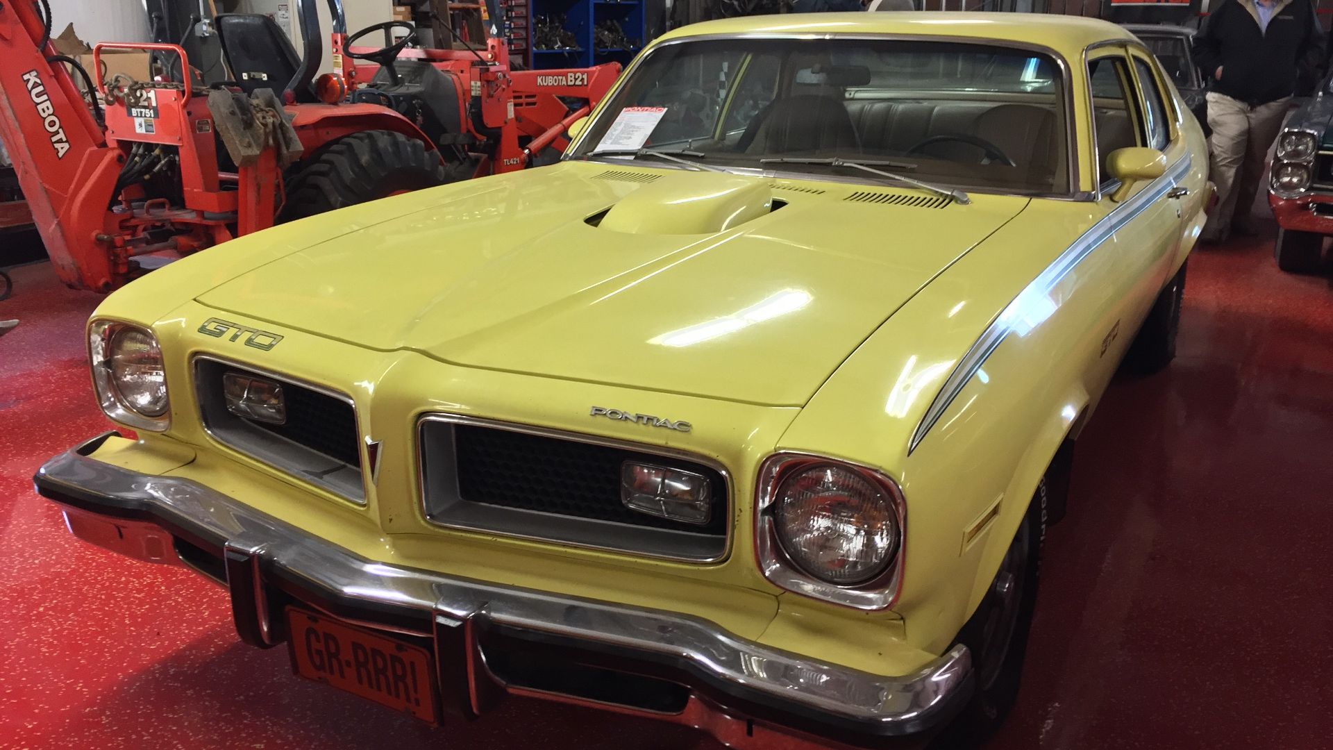 Front left side view of a 1974 Pontiac Ventura with GTO option - this car is in factory original condition finished in yellow