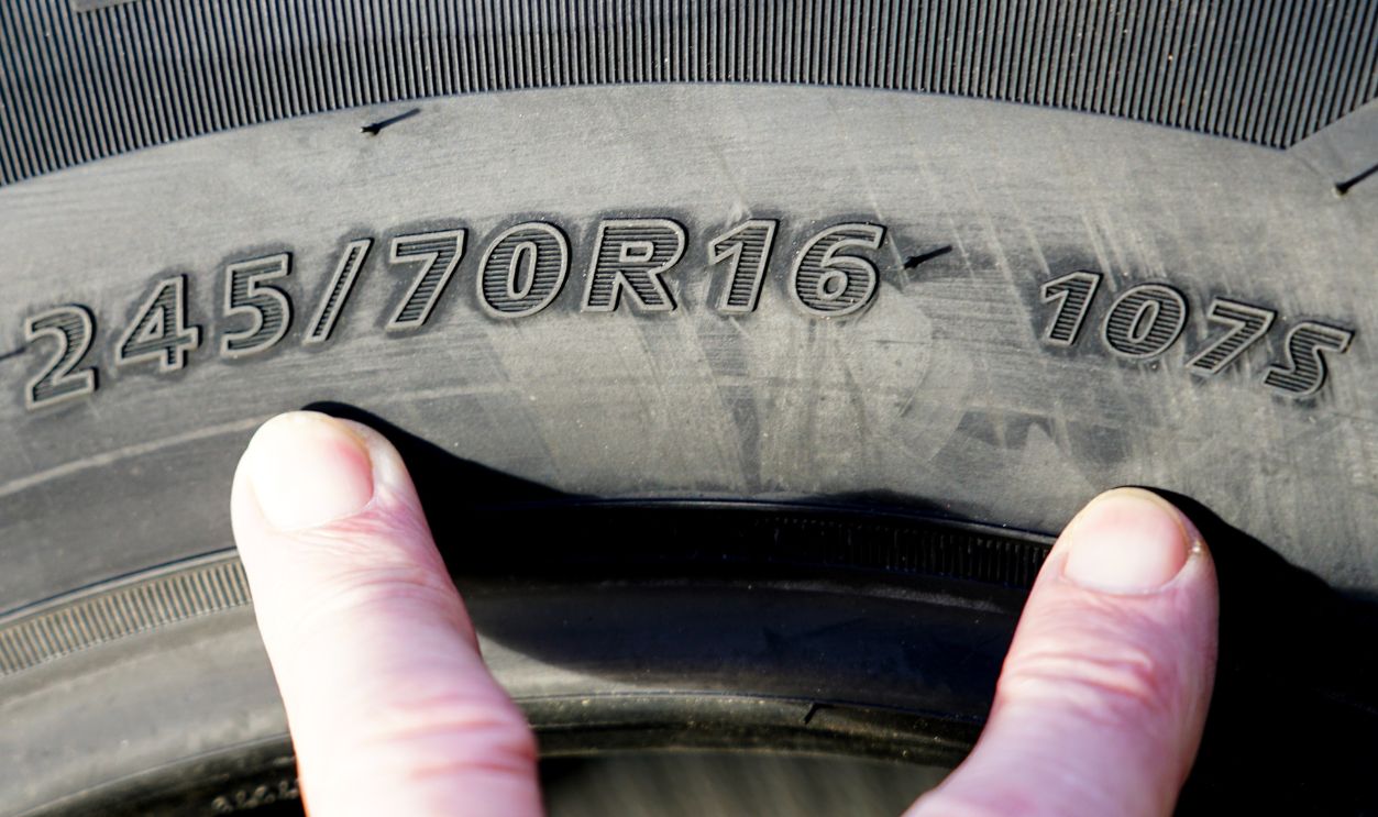 Side view of tire with tire width, height and wheel diameter designations, speed and load indices