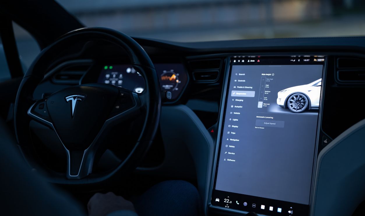 Tesla car interior showcasing advanced touchscreen display and steering controls