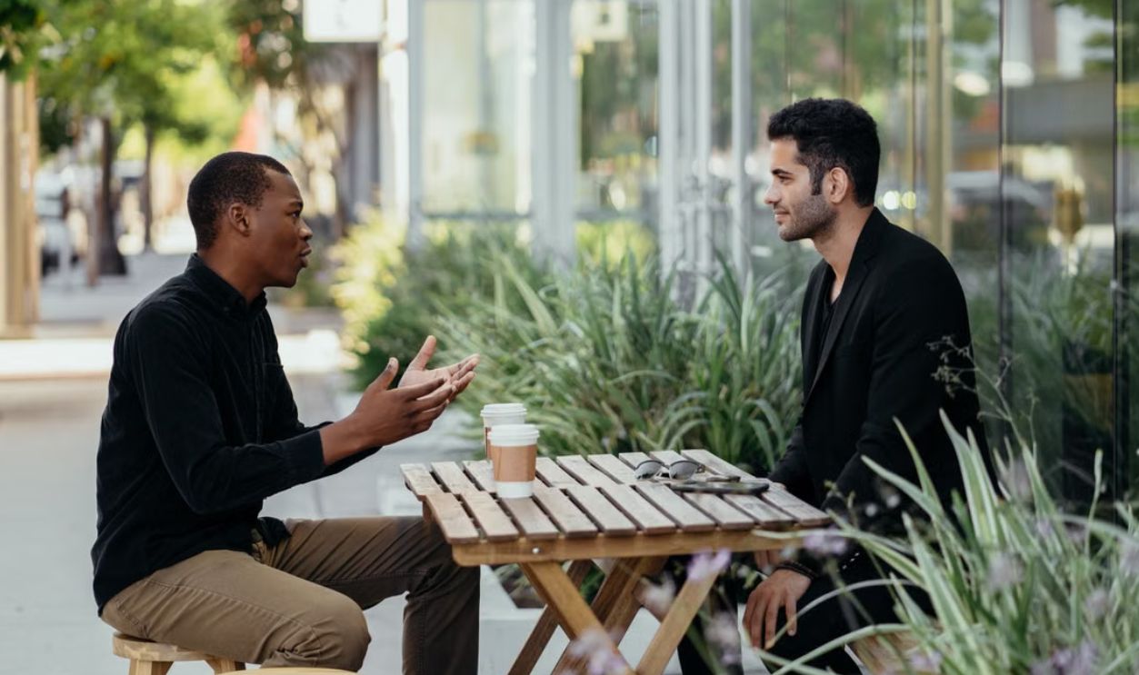 Two men having a business meeting at an outdoor cafe setting