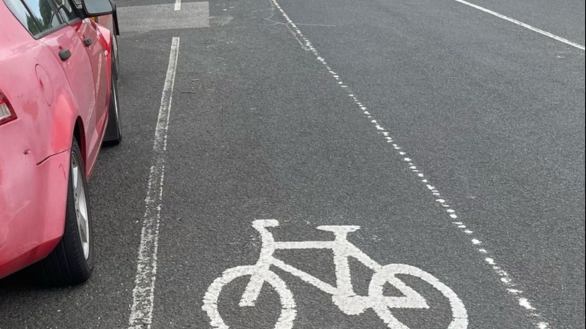 A bike lane in Melbourne with parking on the left hand side