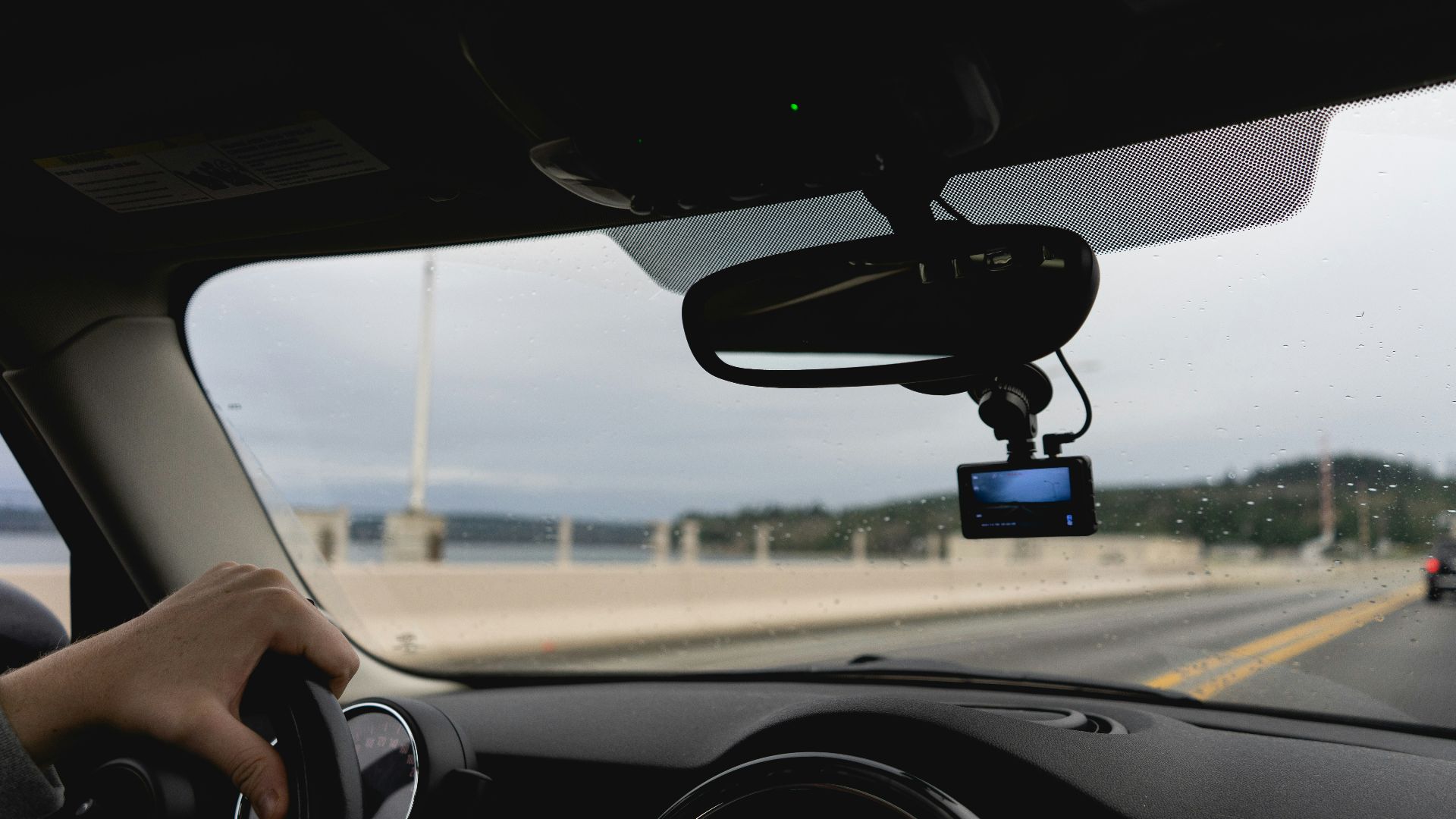 a person driving a car on a highway