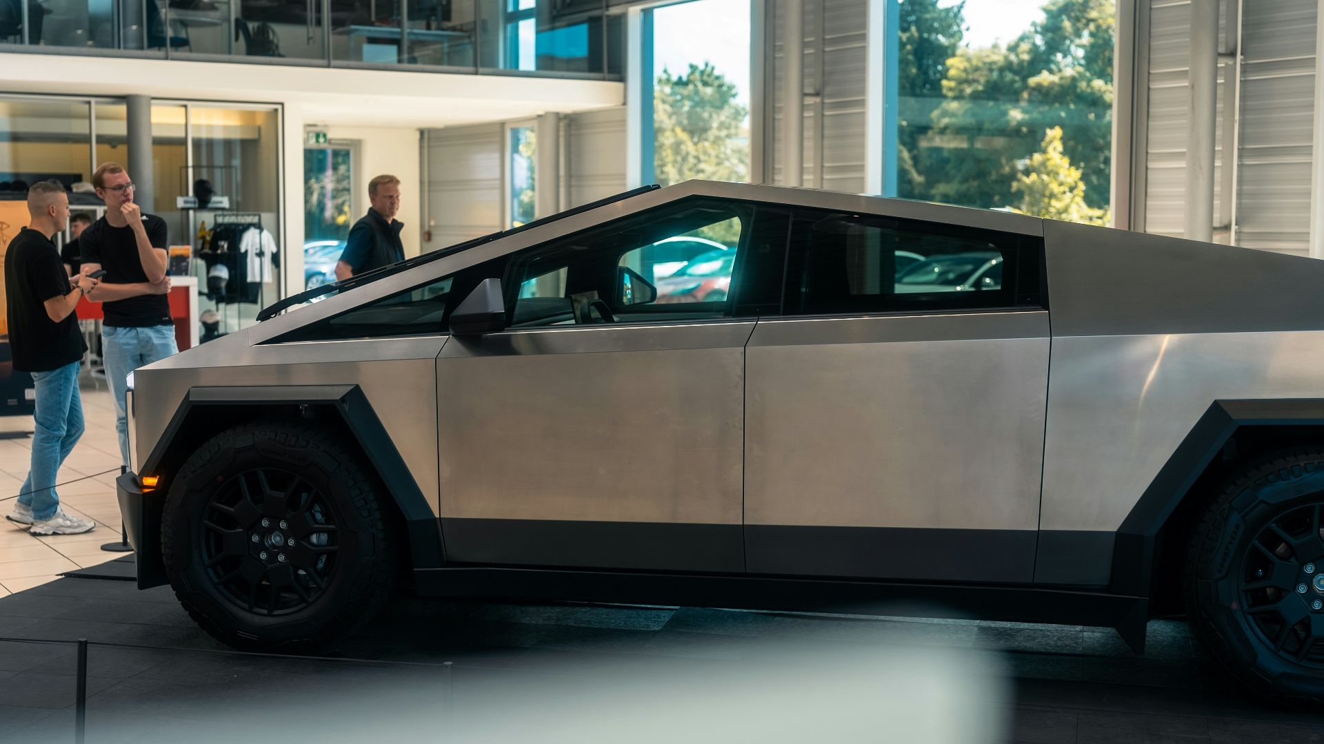 A silver car is parked in a building