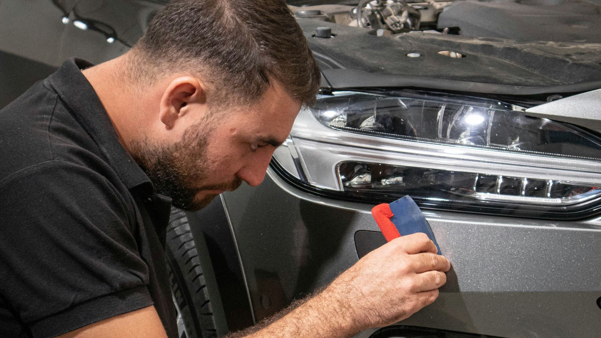 a man working on a car in a garage