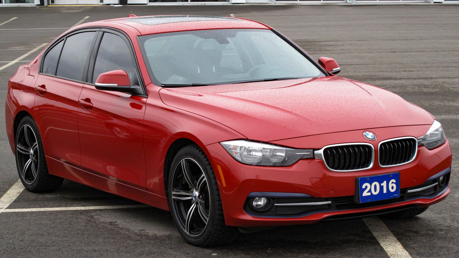 2016 BMW 320i xDrive Sedan photographed in Sault Ste. Marie, Ontario, Canada. Melbourne Red Metallic (A75) over Black Dakota Leather w/ Red Highlight (LCL3), 181-horsepower B48B20 inline-4 paired with an 8-speed ZF automatic, assembled in Regensburg, Ding