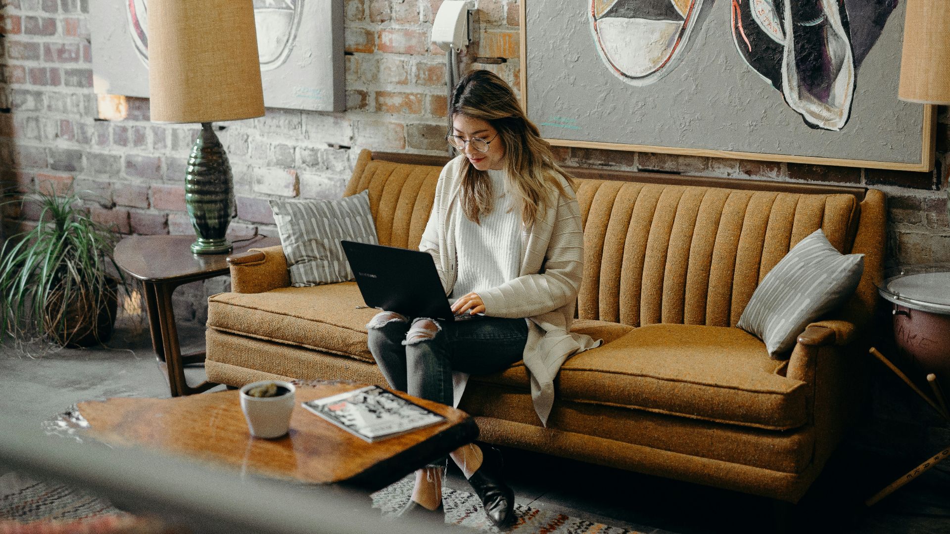 woman using laptop while sitting on chair