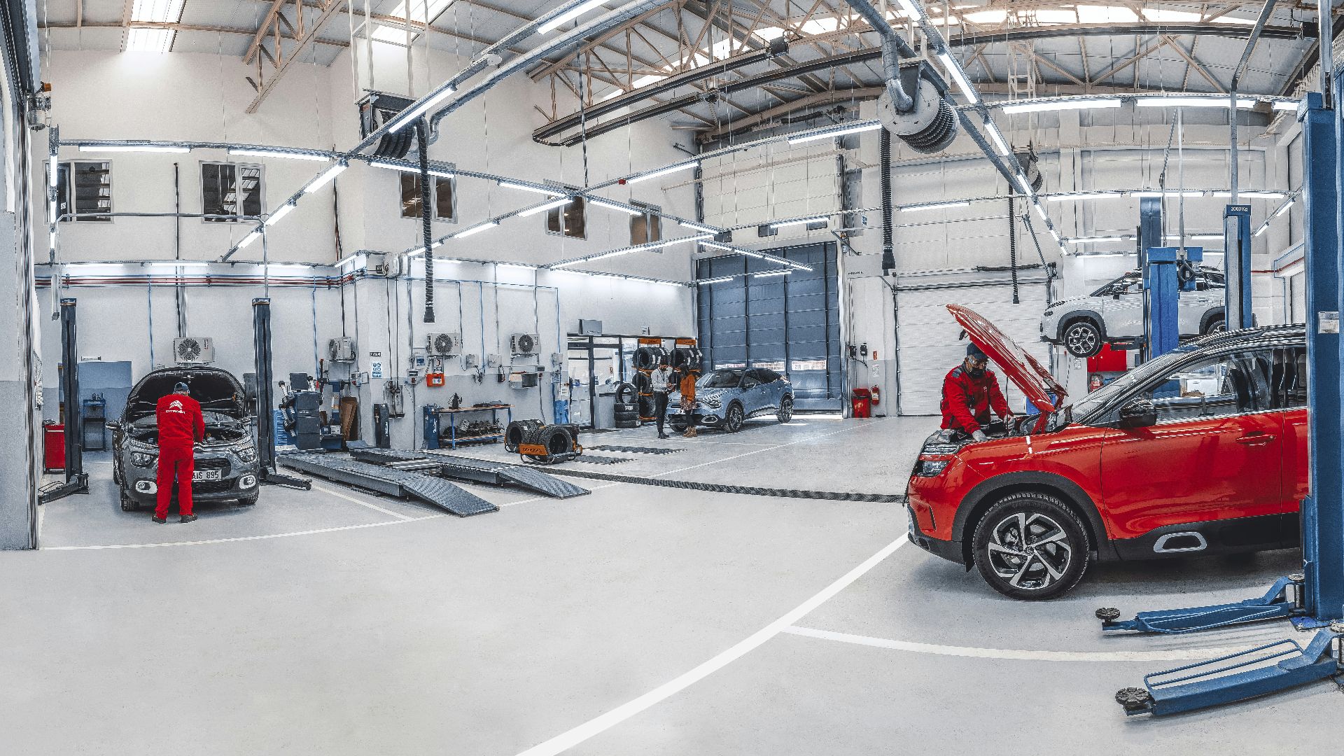 A red car is parked in a garage