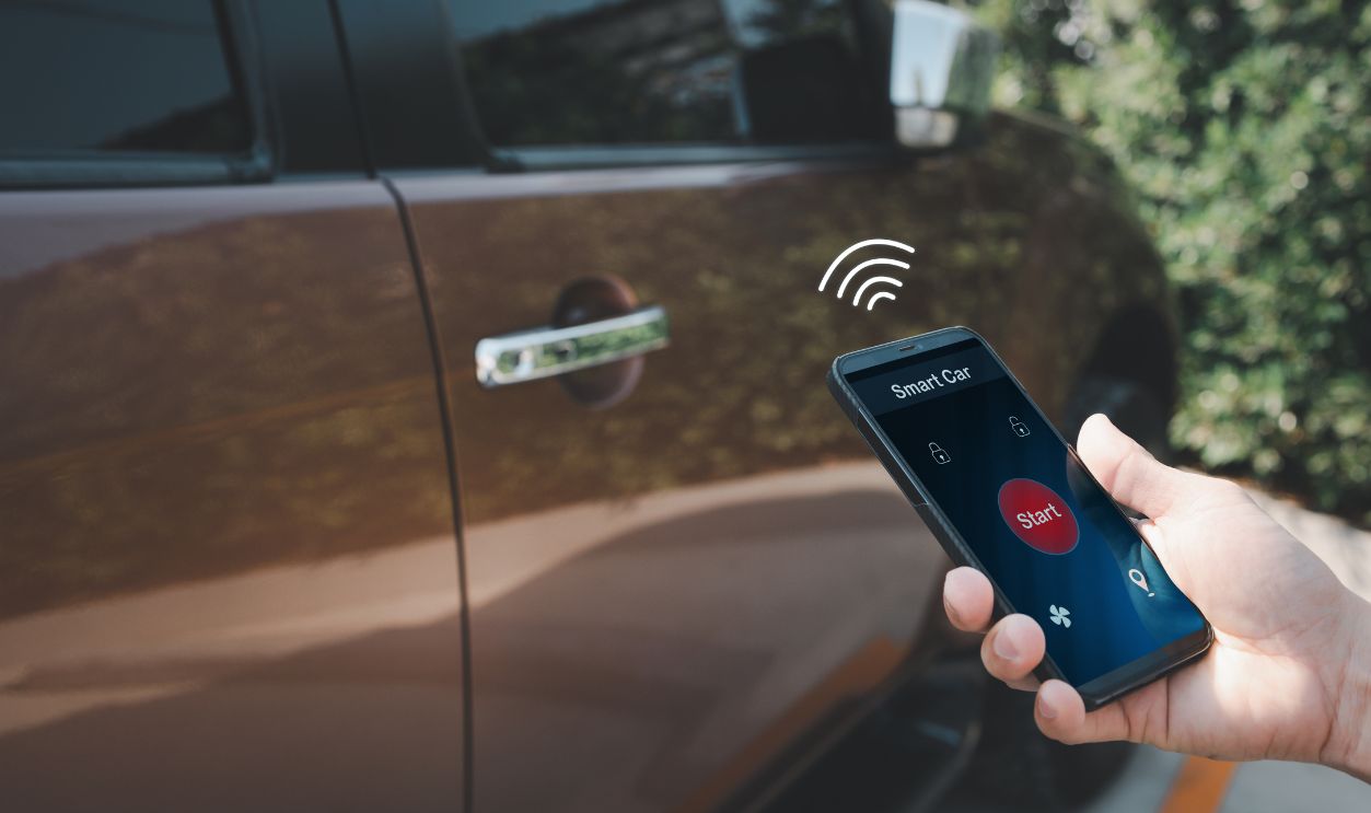 man hand holding smart phone with smart car app screen for unlock and start, wireless technology concept