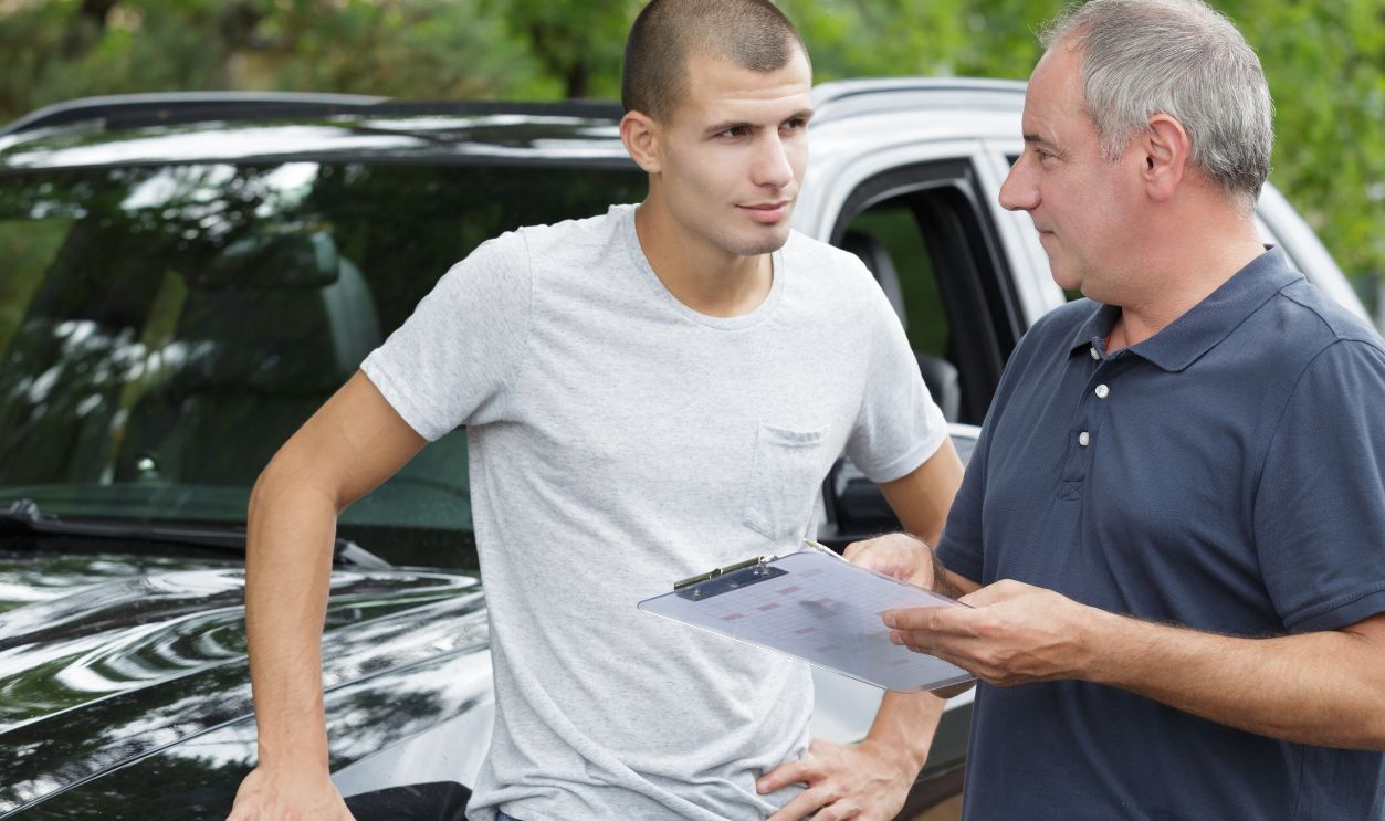 Shutterstock-1516472504, a car dealer holding clipboard