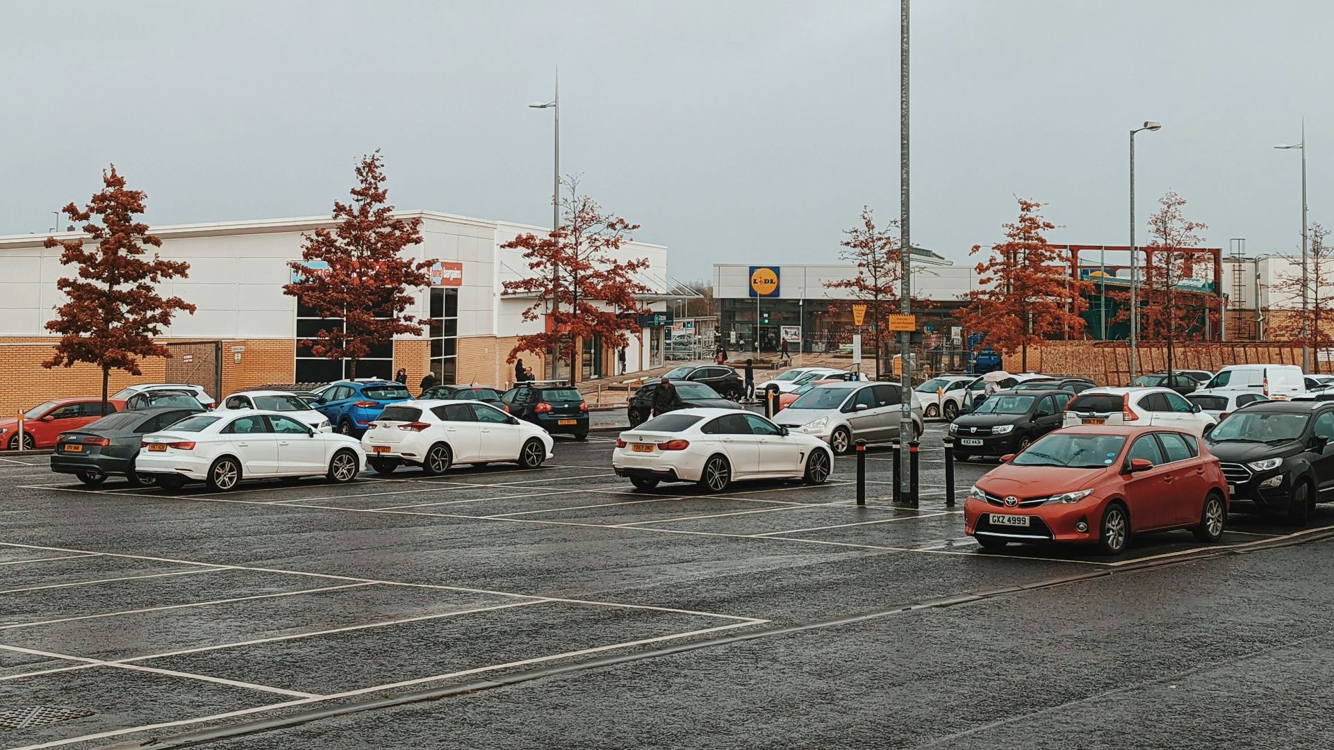 a parking lot filled with lots of parked cars