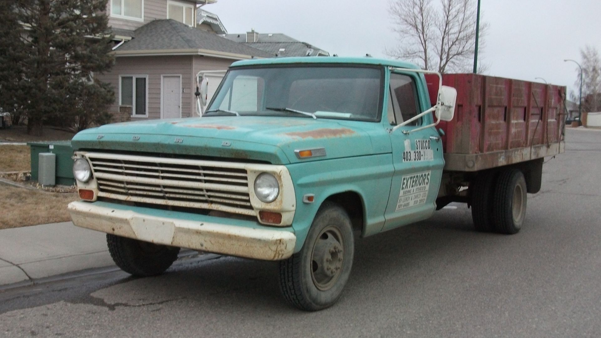 Older Ford truck with stake bed.
