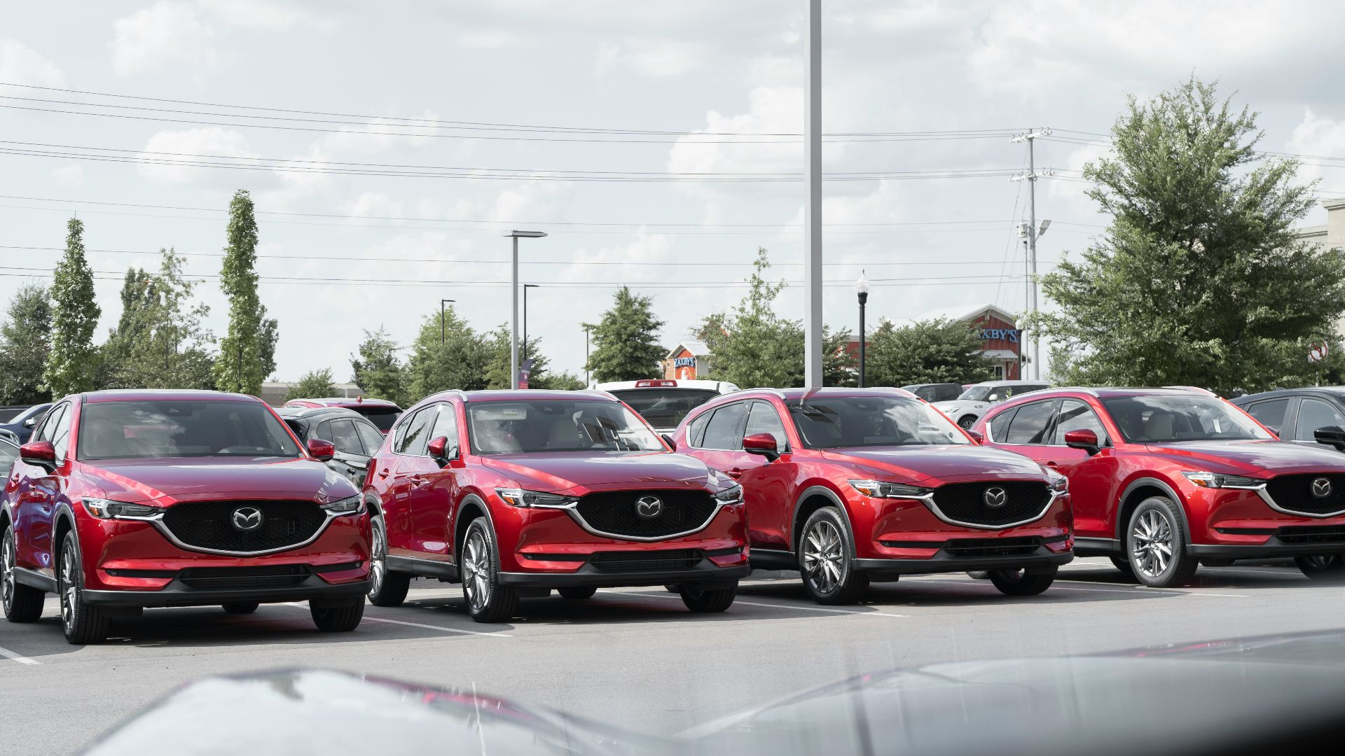a row of cars parked in a parking lot